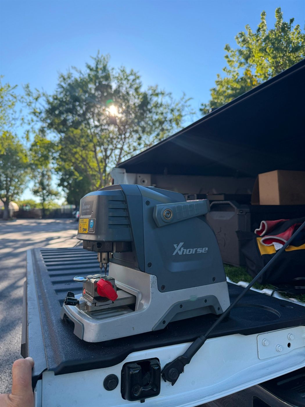 Key cutting machine set up on the tailgate of a work truck