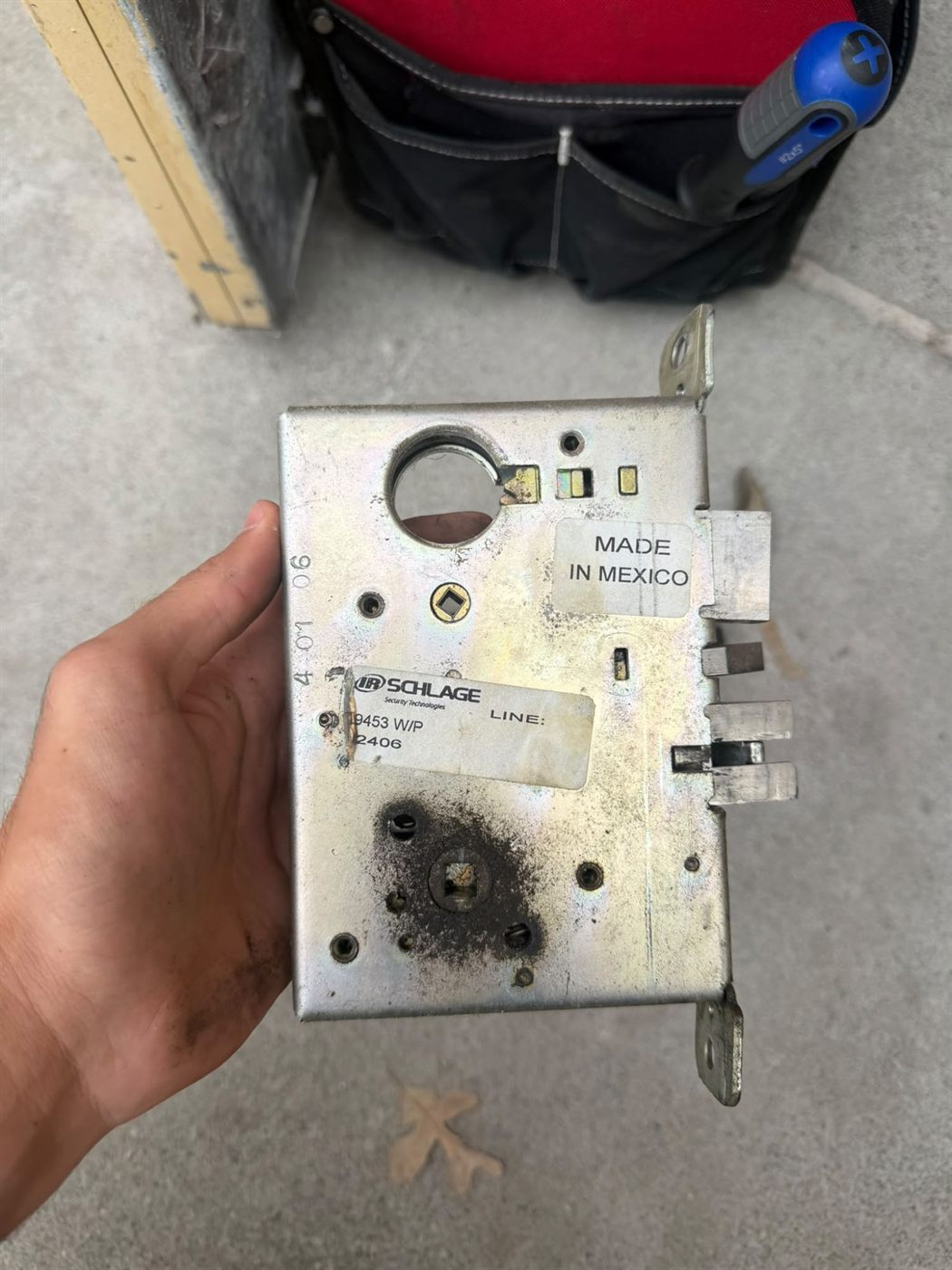 Worn mortise lock body removed from a commercial door for replacement
