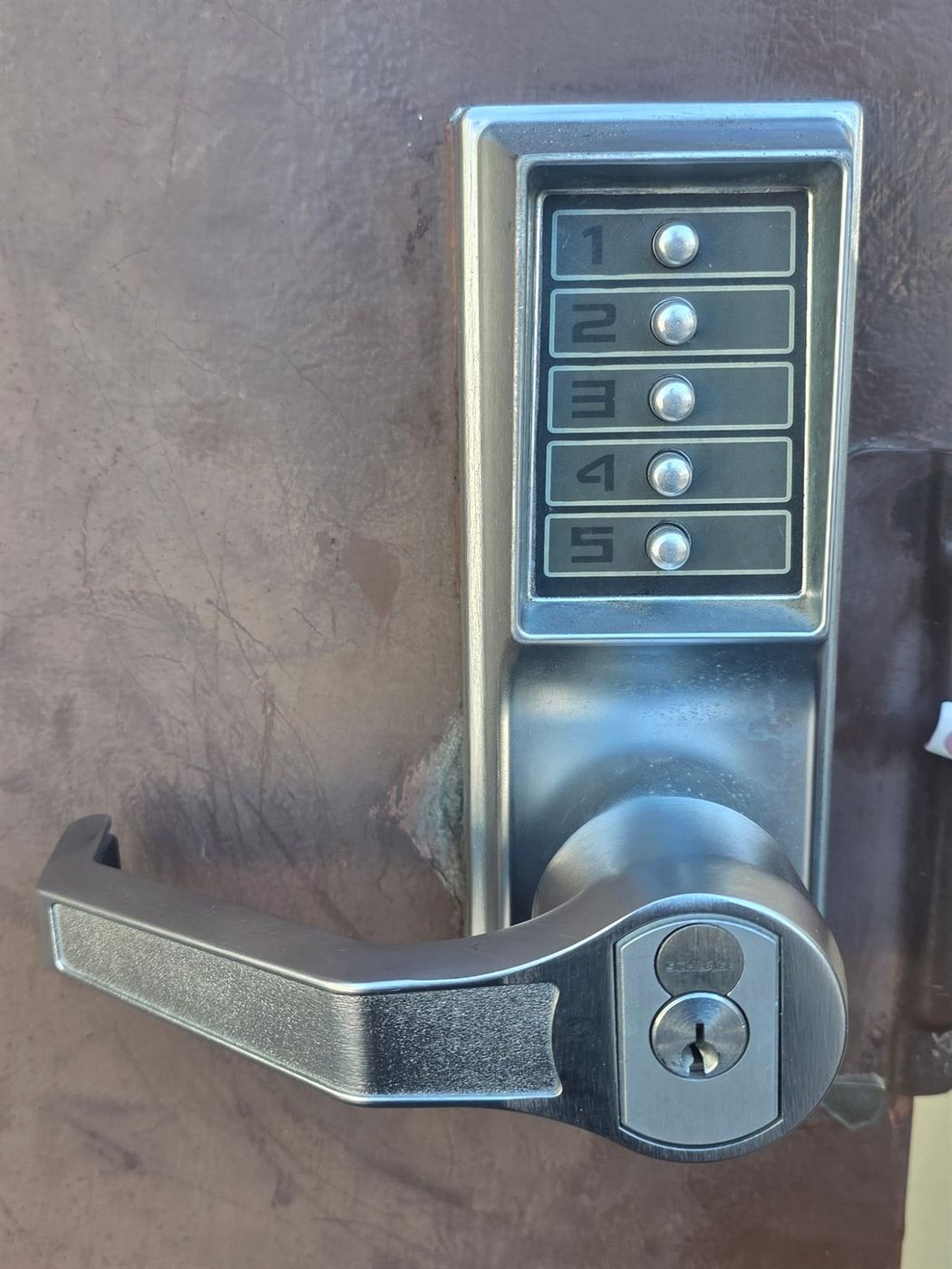 Mechanical push-button keypad lever lock on a metal door