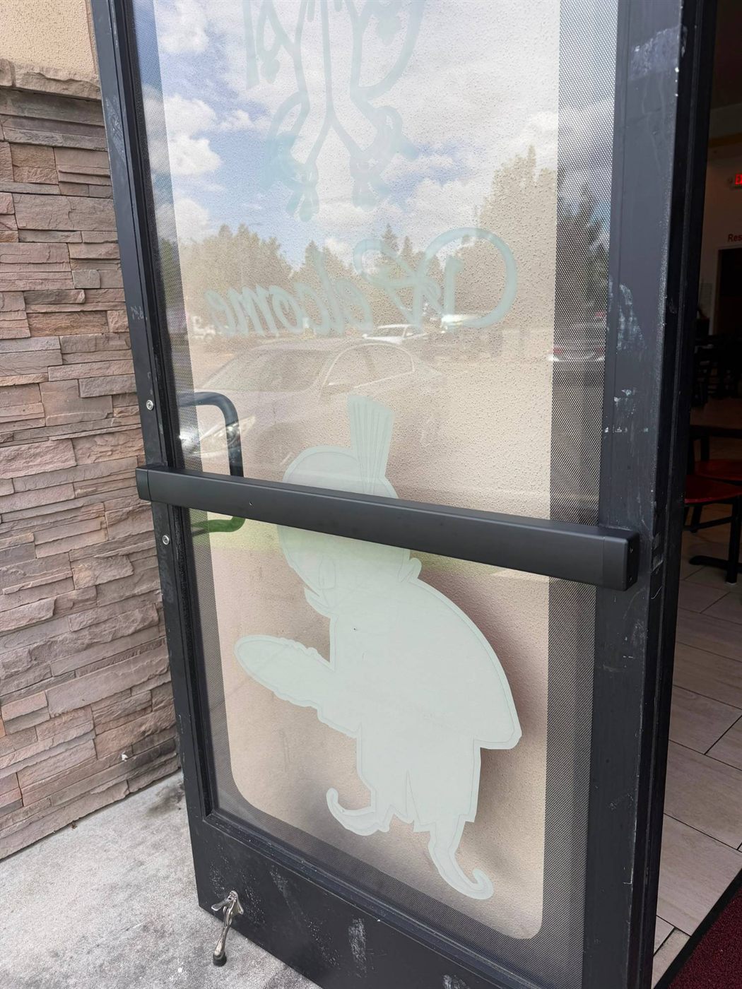 Black panic bar installed on a glass storefront door
