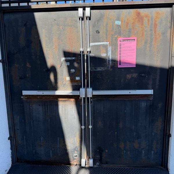 Vertical rod exit devices installed on a pair of steel double doors