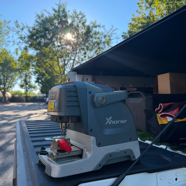 Key cutting machine set up on the tailgate of a work truck