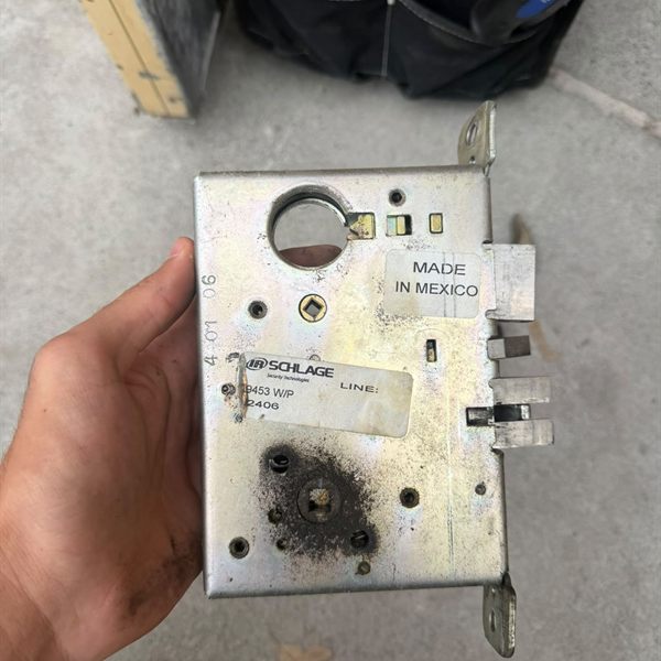 Worn mortise lock body removed from a commercial door for replacement