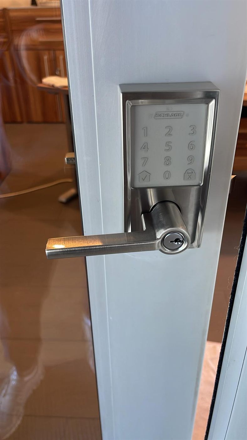 Touchscreen keypad lever lock installed on a glass door frame
